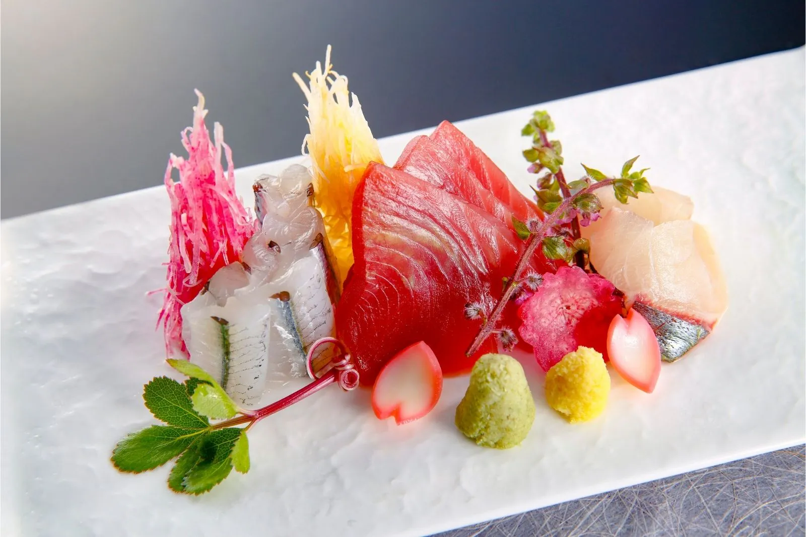 Artfully plated assorted sashimi platter with garnishes at Fusan Dumpling House & Sushi, an Asian Fusion Restaurant in New York